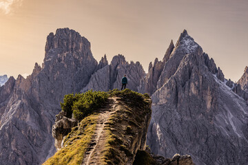 Here, on the mountaintop, he finds a sense of accomplishment, a connection to nature's grandeur, and a well-earned moment of solitude and reflection. - obrazy, fototapety, plakaty