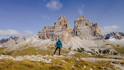 Amidst the breathtaking majesty of the Dolomite Mountains, a rugged and intrepid man stands in awe of nature's grandeur.