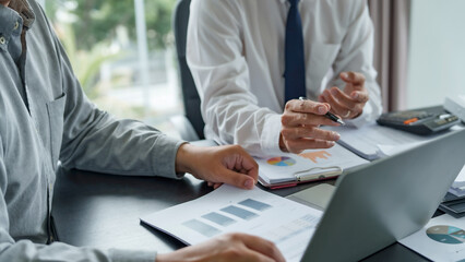 Businesswoman read business document and use calculator to working about calculating tax in office..