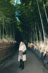 Asian woman traveling in the bamboo forest at Arashiyama Kyoto Japan.