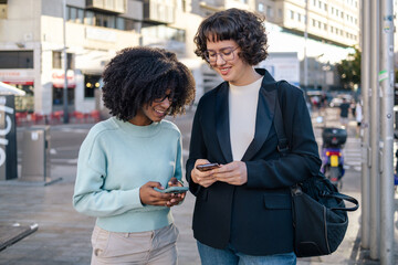 Two friends laughing in the street