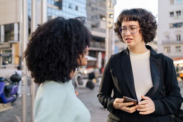Female friends talking in the street