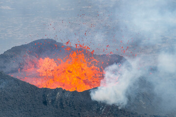 Close up view of lava splashing high and all directions in spatter cone of fissure near Litli-Hrútur Hill during the 2023 eruption near the mountain Fagradalsfjall, Iceland volcano area  - obrazy, fototapety, plakaty