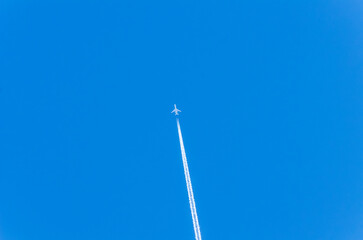 The plane is flying in a blue sky without clouds.