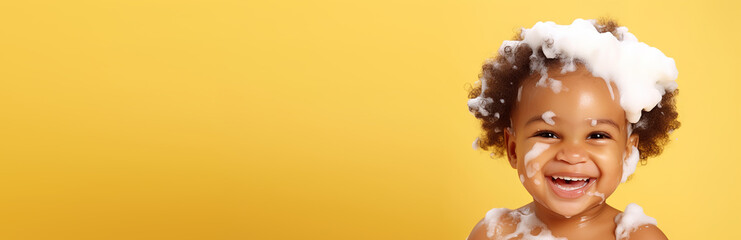 banner copyspace Little smiling african American baby girl with big soap foam on head in hair. on solid yellow background, Shampoo, hair treatment and soap for children, childs bathing time