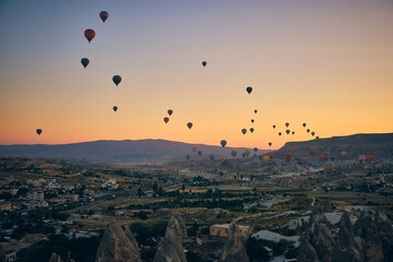 Aerial view of hot air balloons above spectacular volcanic landscape of Cappadocia. Goreme national park. UNESCO World Heritage site. Nevsehir province, Turkiye