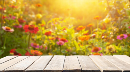 Empty wooden table and flower garden background, Sunset or sunrise time