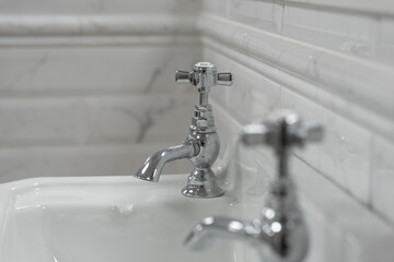 Bathroom tap, chrome faucet and vase, tiled walls, restroom sink, interior design