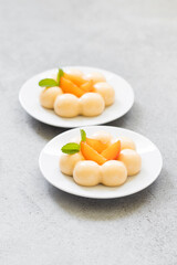 Apricot cream dessert, Panna Cotta in the shape of truffles, decorated with fresh apricot slices