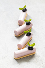 Vegan Blackberry cream dessert bar on cookies. Decorated with fresh blackberry