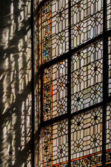 Light streaming through a stained glass window inside Saint-Paul church in Paris