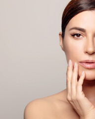 Glowing and youthful woman with moisturized skin in relaxing spa treatment. With copyspace.