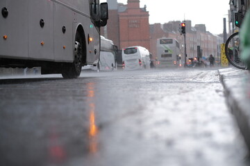 Low angle still image of the road during rainy day with cars and buses in the background in Dublin,...