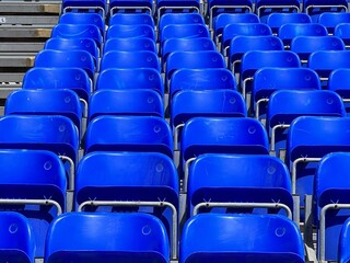 Identical blue chairs at the stadium.