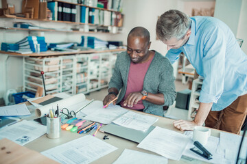 Obraz premium Two male architects working on a project together in a modern office