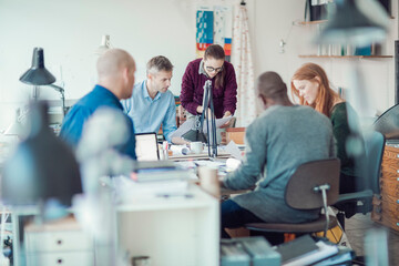 Obraz premium Group of people working together on a project in a startup company office