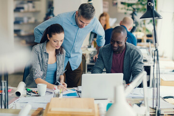 Group of people working together on a project in a startup company office