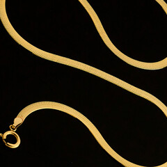 Gold jewelry, gold chain on black background