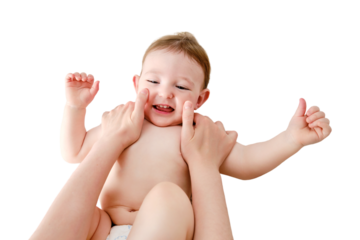 The mother smears the face of the toddler baby boy with cosmetic cream, isolated on a white background. Mom hands apply cream to the child skin, isolated on a white background. Kid aged one year