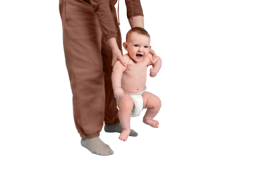 Mom teaches the child to stand on his feet and walk, baby boy isolated on a white background