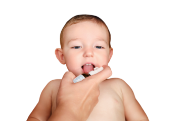 A mother woman sprays medicine into the mouth of a toddler baby boy, isolated on a white background. Mom gives a happy child liquid vitamins, isolated on a white background. Kid age one year