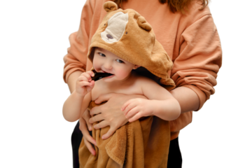 A mother woman and a happy toddler baby brush their teeth, isolated on a white background. Mom and child learn to brush their teeth with a toothbrush. Kid aged one year and three months