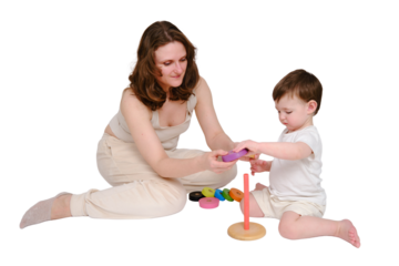 Happy baby with mother play educational toys on studio, isolated on white background. Portrait of a smiling child with mom and playing while sitting on the floor. Kid about two years old