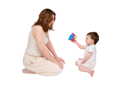 Happy baby with mother play educational toys on studio, isolated on white background. Portrait of a smiling child with mom and playing while sitting on the floor. Kid about two years old