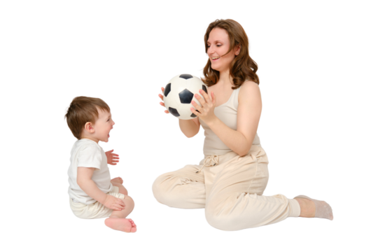 Happy baby with mother play with fotball ball on studio, isolated on white background. Portrait of a smiling child with mom and playing while sitting on the floor
