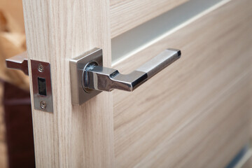 Locks and handles on doors.Installation of locks on interior doors. - obrazy, fototapety, plakaty