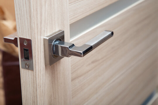 Locks and handles on doors.Installation of locks on interior doors.