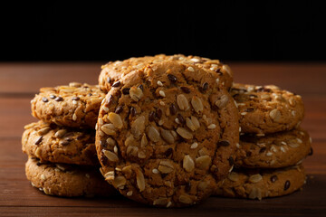 Oatmeal cookies on the table and on a dark background.