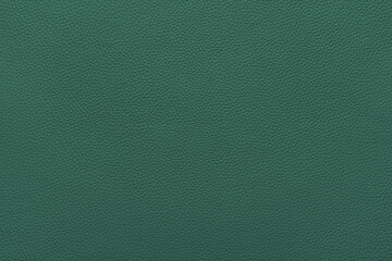 Genuine green leather, eco friendly leatherette texture background. Material for upholstery and interior design, sport items and clothes. Wallpaper, banner, backdrop.