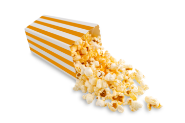 Tasty cheese popcorn falling out of yellow striped carton bucket, isolated on white, transparent background, PNG. Scattering of popcorn grains. Movies, cinema and entertainment concept.