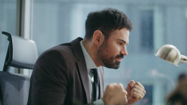 Stressed businessman quarrelling zoom conference sitting luxury office close up.