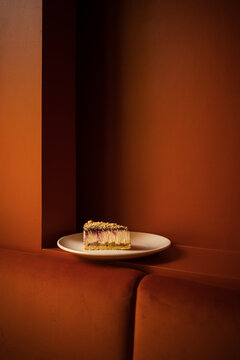 A piece of cheesecake on red background at the restaurant 
