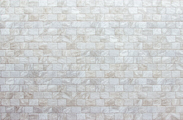 Empty background of wide cream brick wall texture. Beige old brown brick wall concrete or stone textured, wallpaper limestone abstract flooring. Grid uneven interior rock. Home decor design backdrop.