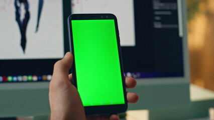 Man hands holding mockup mobile phone office closeup. Artist using chromakey app