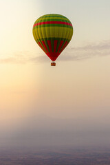 hot air balloon in the sky in Morocco flying over the atlas mountain at sunset