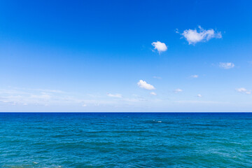 Mediterranean sea horizon line in bright blue sky background.