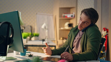 Talking freelancer explaining phone call at monitor closeup. Man drawing tablet