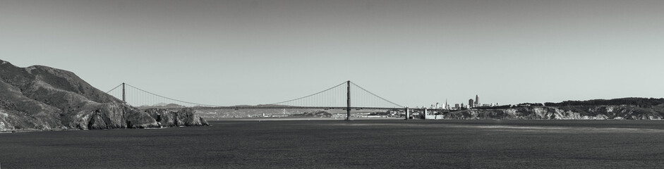 Fototapeta na wymiar Black and white panorama of the golden gate with downtown San Fransisco in the background 