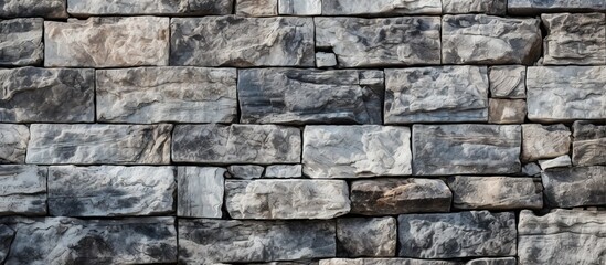 Texture background of aged granite stones parapet fragment close up Rough masonry surface