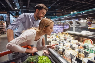 Foto op Plexiglas Couple at the supermarket © georgerudy