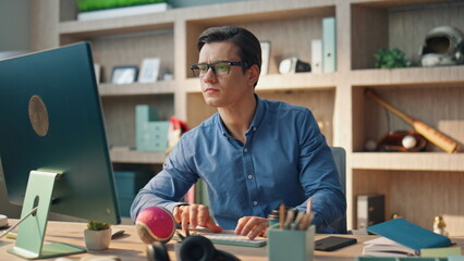 Thoughtful freelancer texting computer working in office closeup. Man chatting