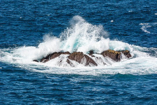 Bombora, sea waves breaking over shallow reef and rock.