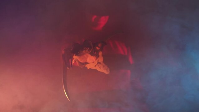 scary hand of  man is like a serial killer freddy with a glove sharp knives in the mist, background for Halloween