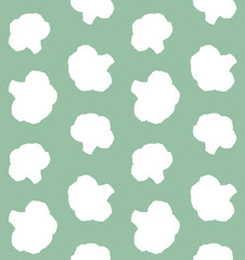 Vector seamless pattern of hand drawn broccoli silhouette isolated on green background