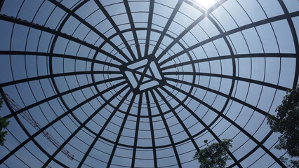 view inside a large aviary dome with curved steel in the form of dome