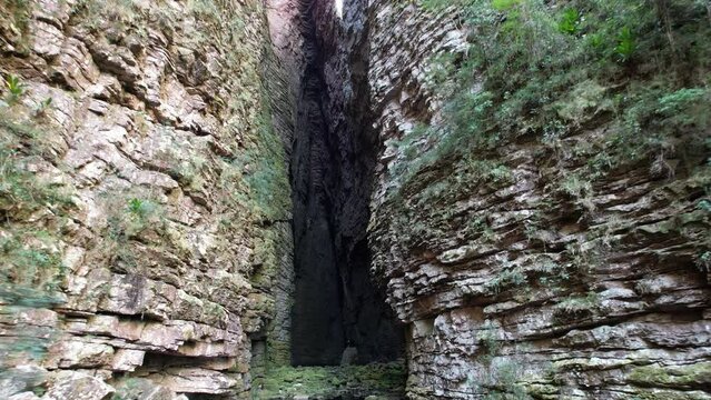 Fumacinha waterfall crevice drone video, Vale do Pati, Chapada Diamantina, Bahia, Brazil. Valley with cerrado and caatinga biome, waterfall, abundant nature, hills, valley and canyons